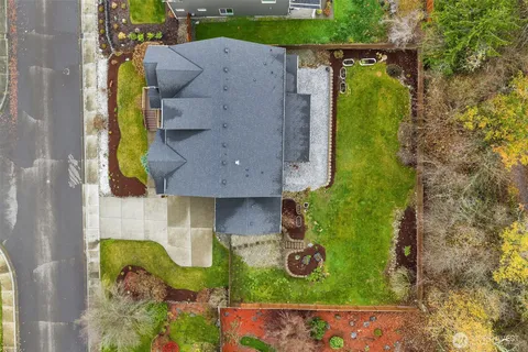 an aerial view of residential house with yard