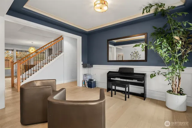 a living room with furniture and a piano