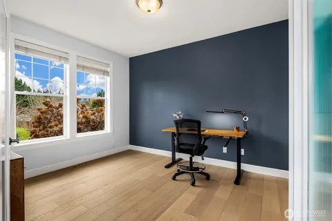 a view of a workspace with furniture and a window