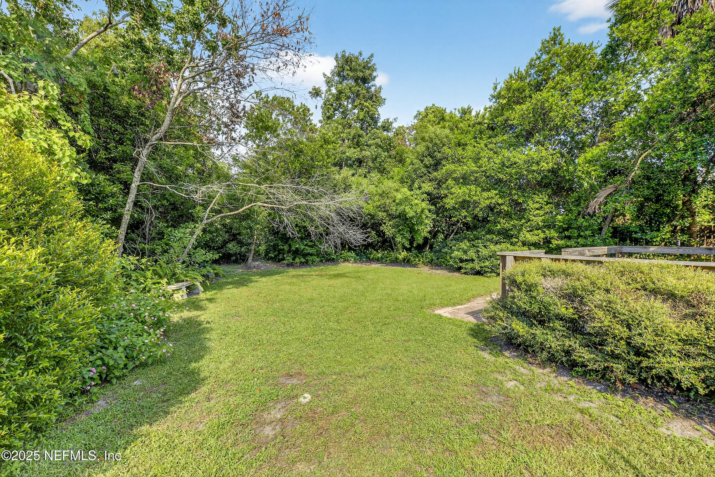 1425 Pinetree Road Jacksonville, FL 32207 - Photo 11 of 39 a view of a field with trees in the background