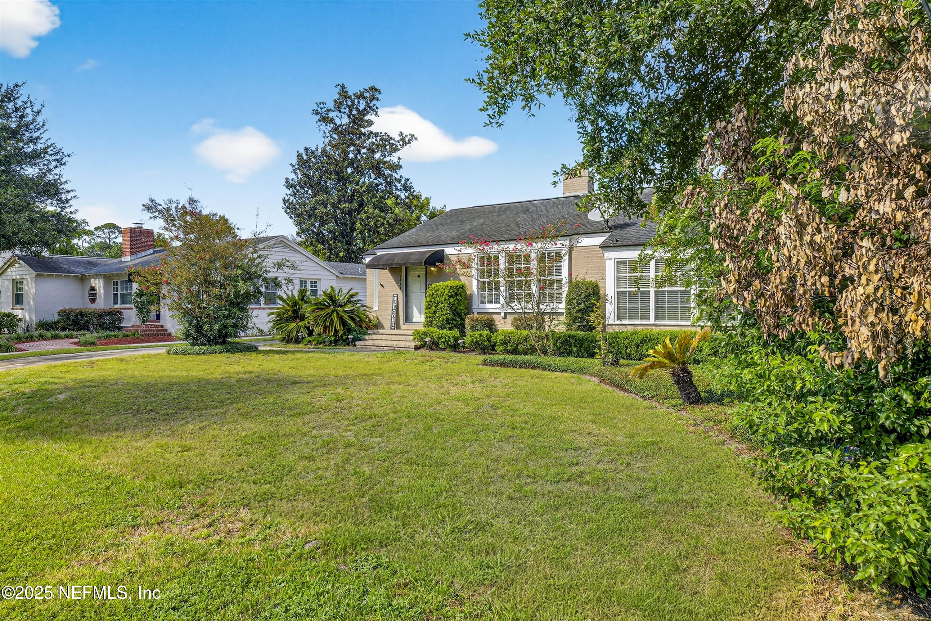 1425 Pinetree Road Jacksonville, FL 32207 - Photo 14 of 39 a view of a house with a big yard and potted plants