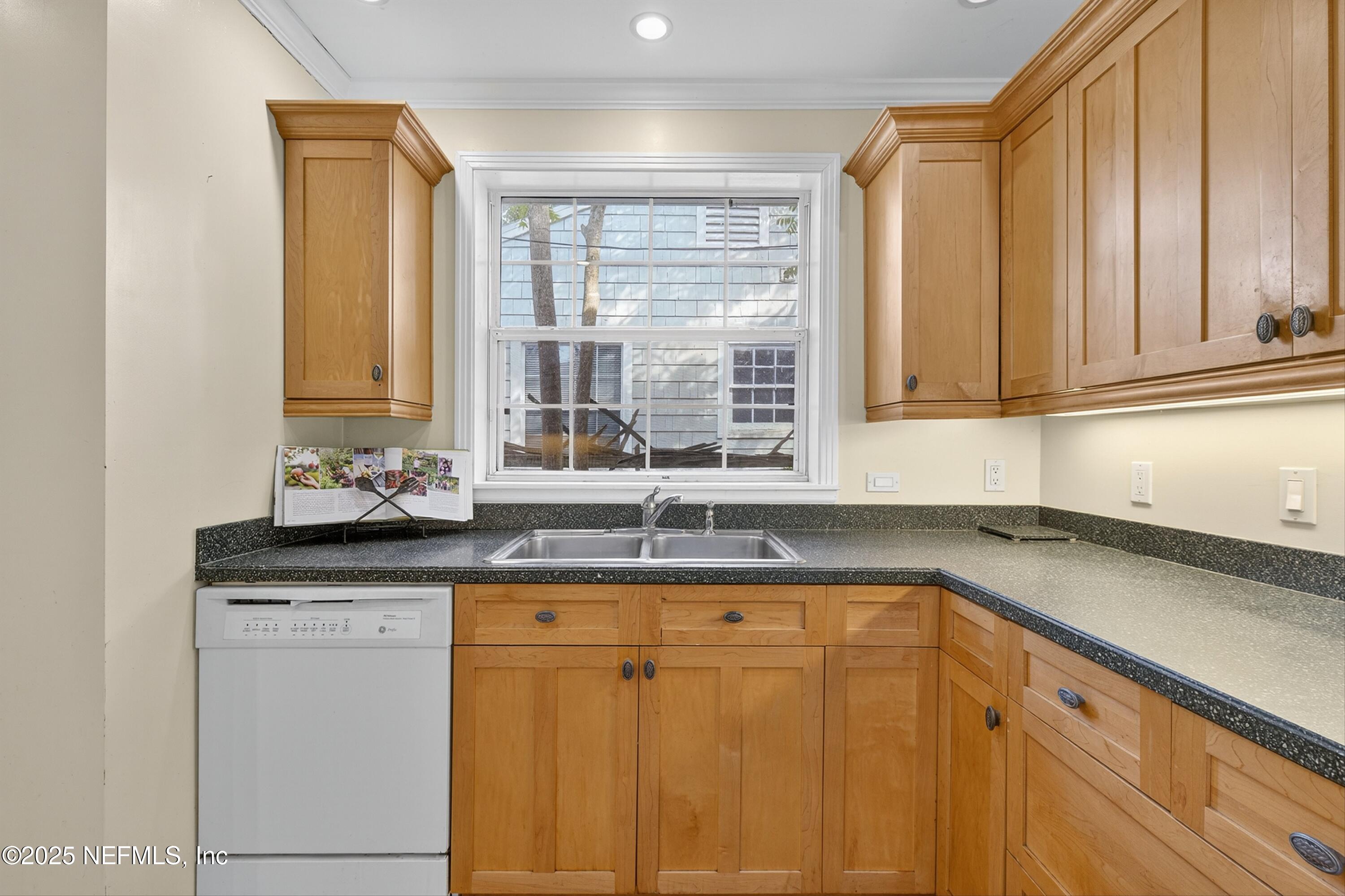 1425 Pinetree Road Jacksonville, FL 32207 - Photo 20 of 39 a kitchen with granite countertop cabinets sink and window