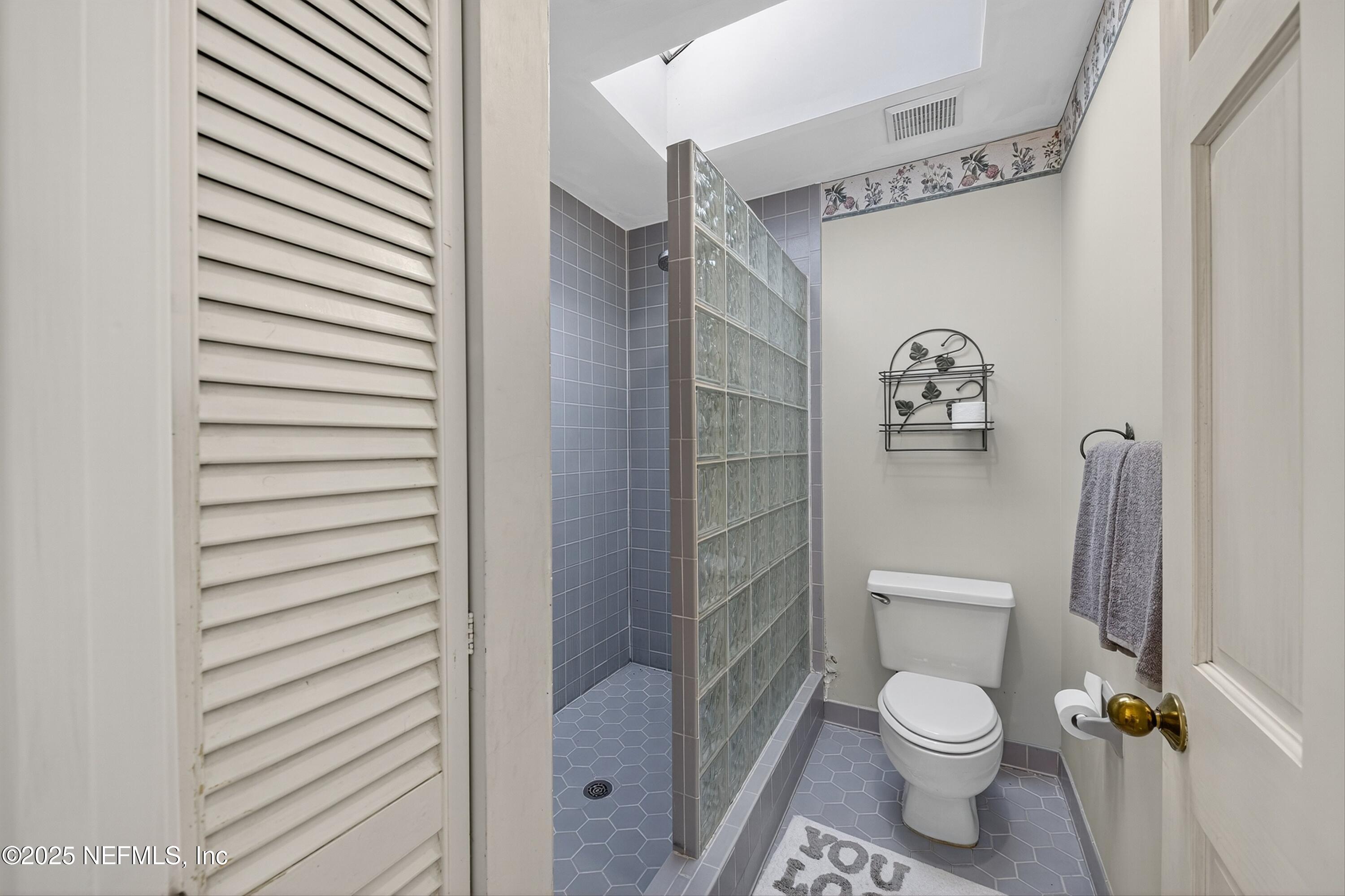 1425 Pinetree Road Jacksonville, FL 32207 - Photo 29 of 39 a white toilet sitting next to a bathroom sink and vanity