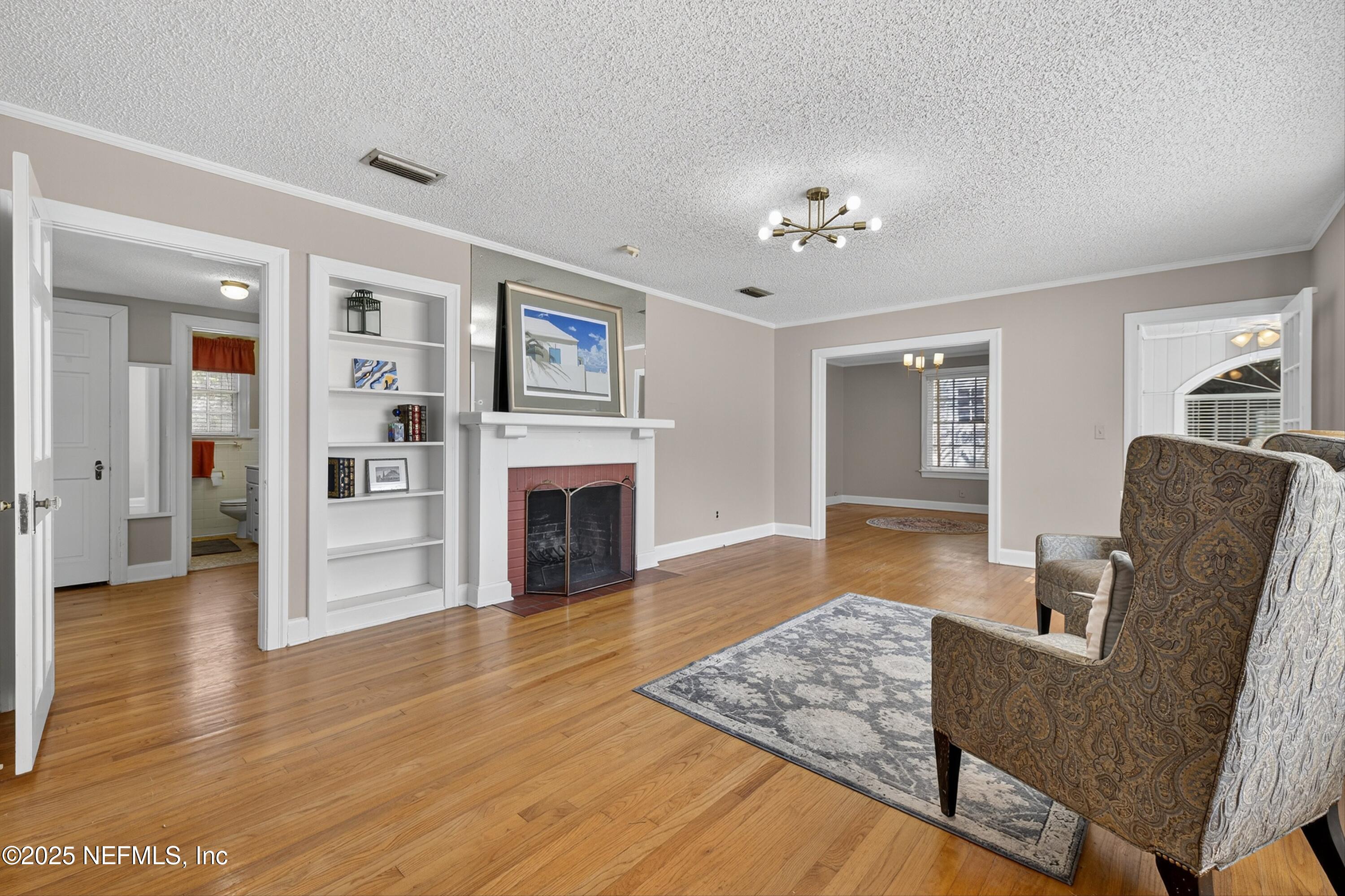 1425 Pinetree Road Jacksonville, FL 32207 - Photo 3 of 39 a living room with furniture and a fireplace