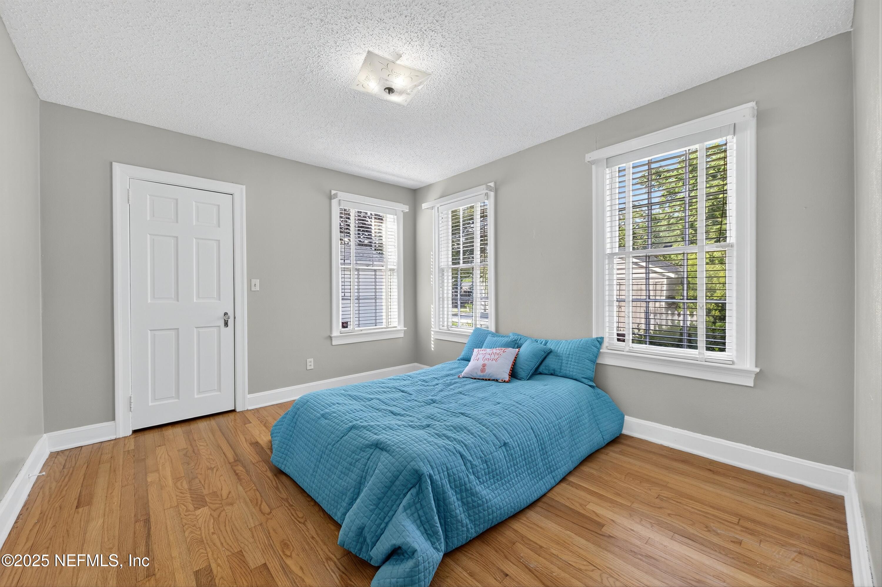 1425 Pinetree Road Jacksonville, FL 32207 - Photo 32 of 39 a bedroom with a bed and wooden floor