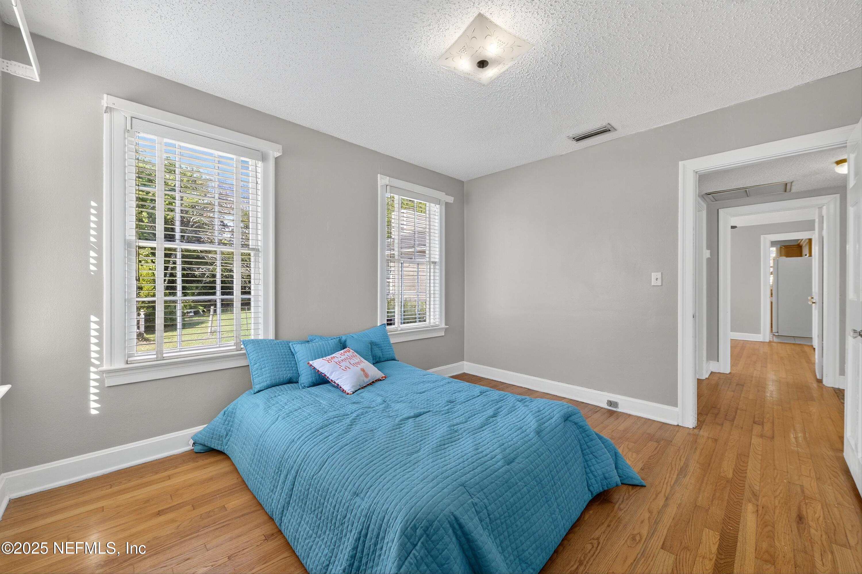 1425 Pinetree Road Jacksonville, FL 32207 - Photo 33 of 39 a bedroom with a bed and wooden floor