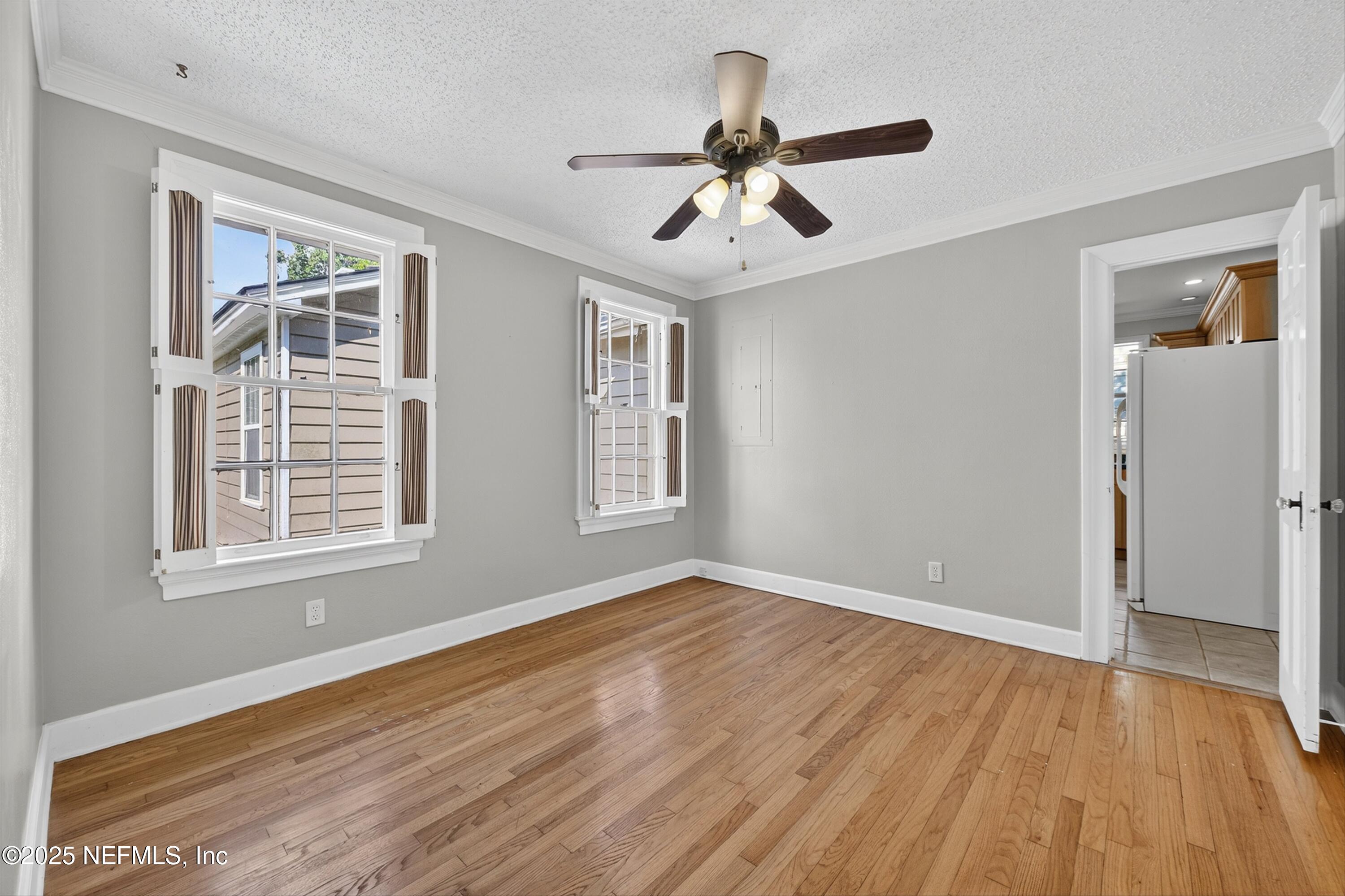 1425 Pinetree Road Jacksonville, FL 32207 - Photo 37 of 39 a view of an empty room with wooden floor and a window