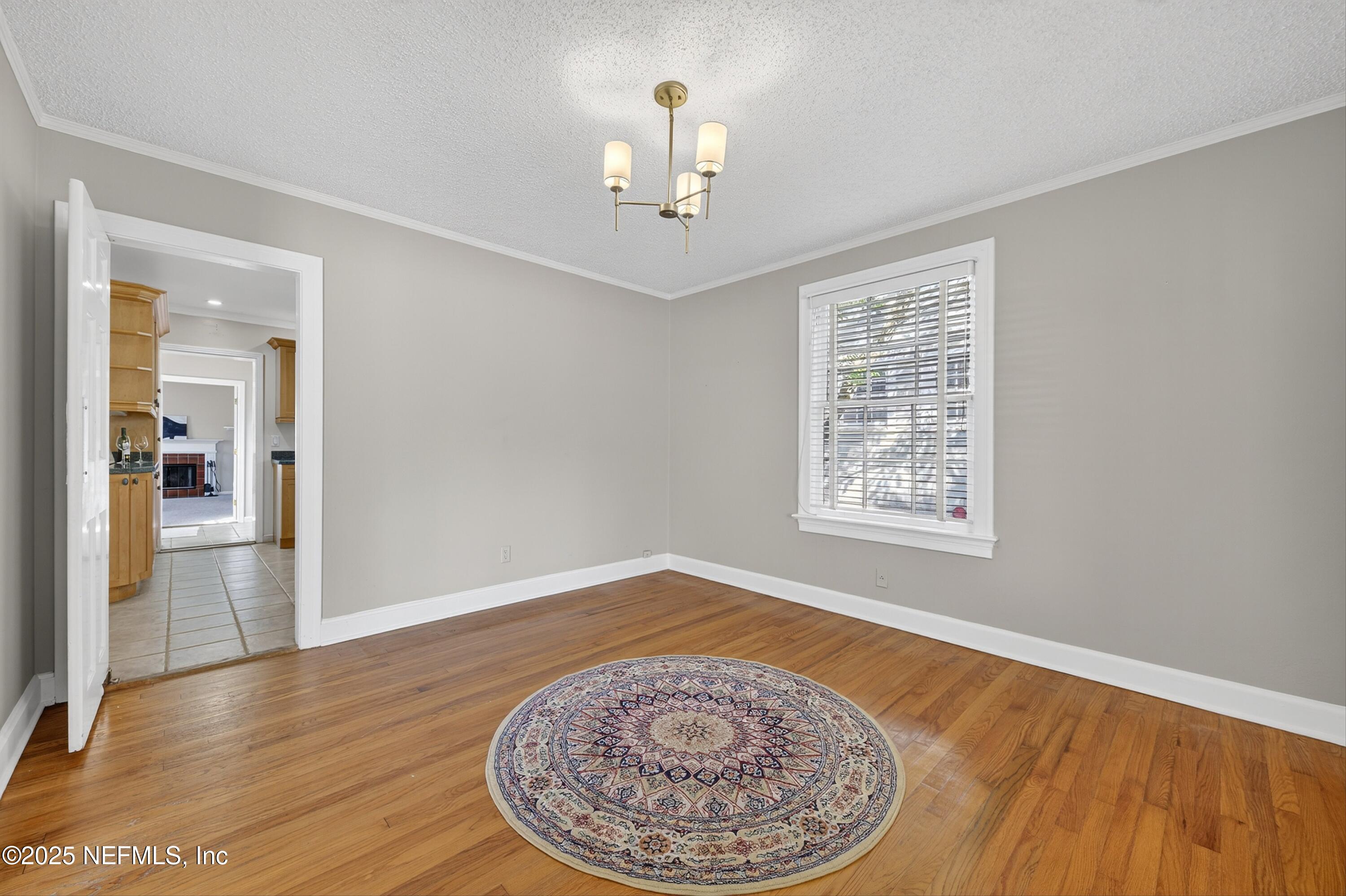 1425 Pinetree Road Jacksonville, FL 32207 - Photo 8 of 39 wooden floor in an empty room with a window
