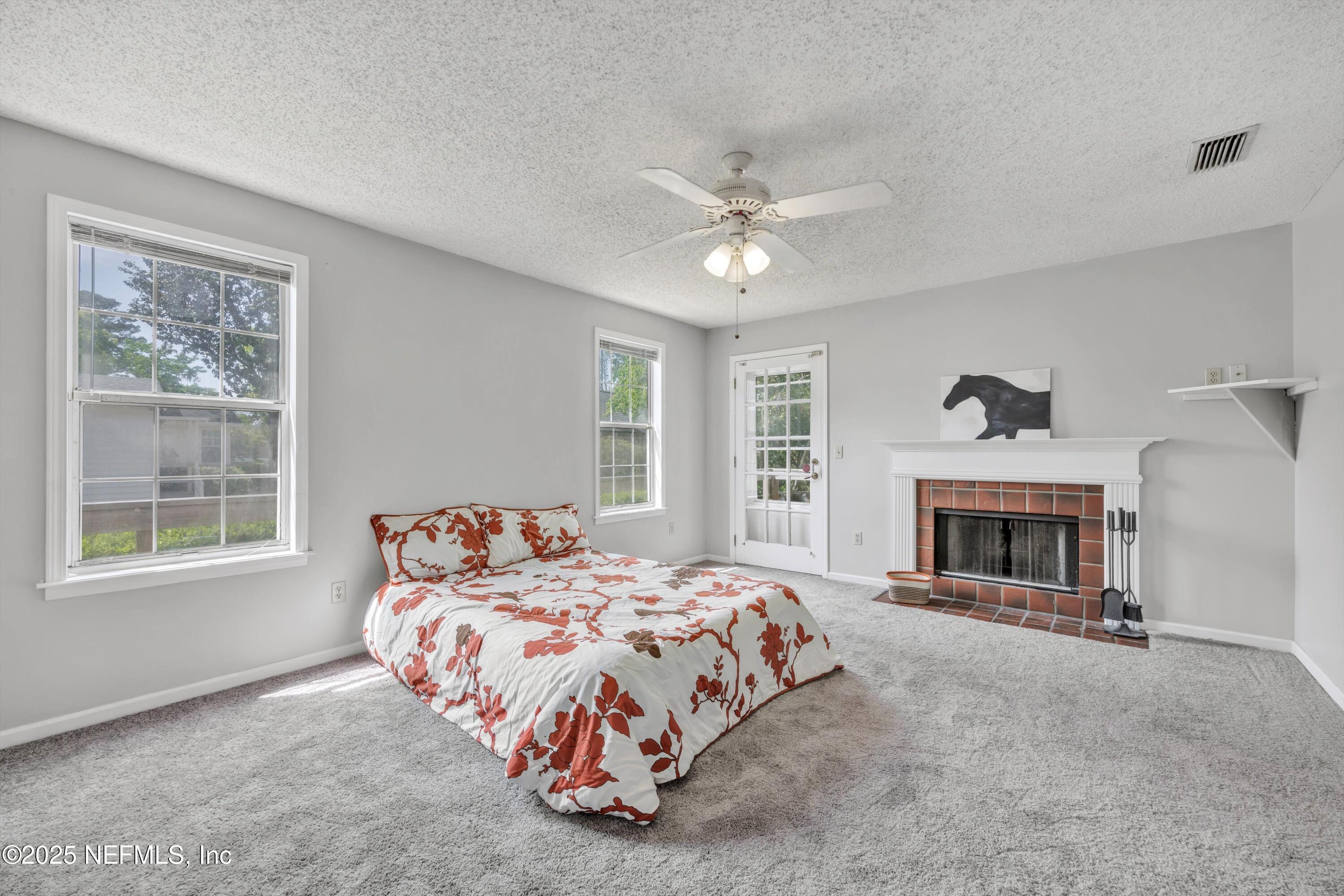 1425 Pinetree Road Jacksonville, FL 32207 - Photo 10 of 39 a bedroom with bed and a fireplace