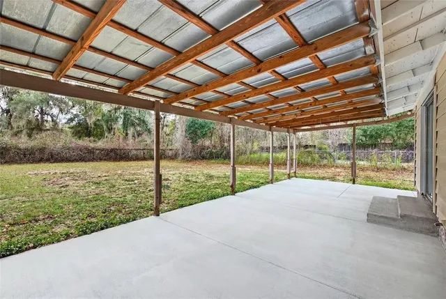 a view of a house with a big yard and potted plants