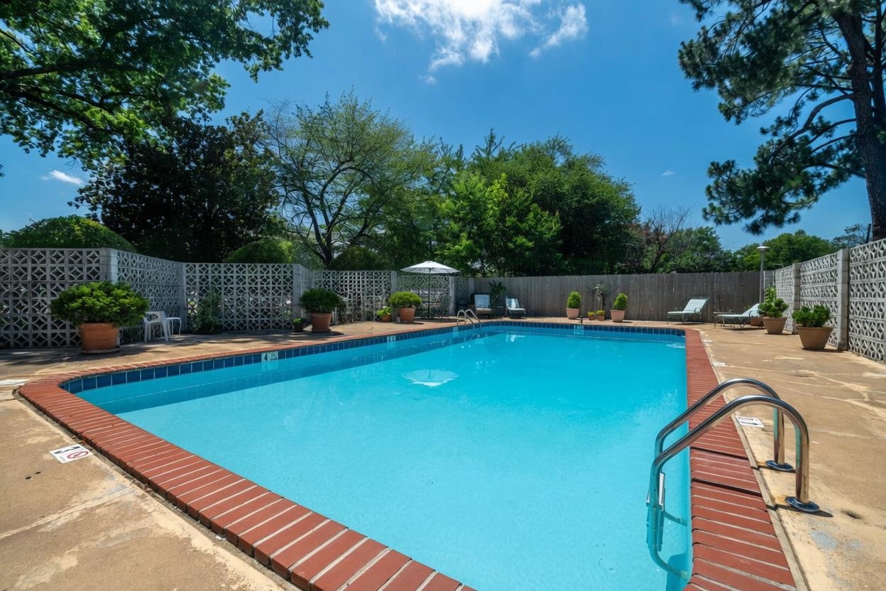 3080 Walnut Grove Road, Unit 306 Memphis, TN 38111 - Photo 16 of 18 Outdoor swimming pool with a concrete surround, brick coping, and steel handrails