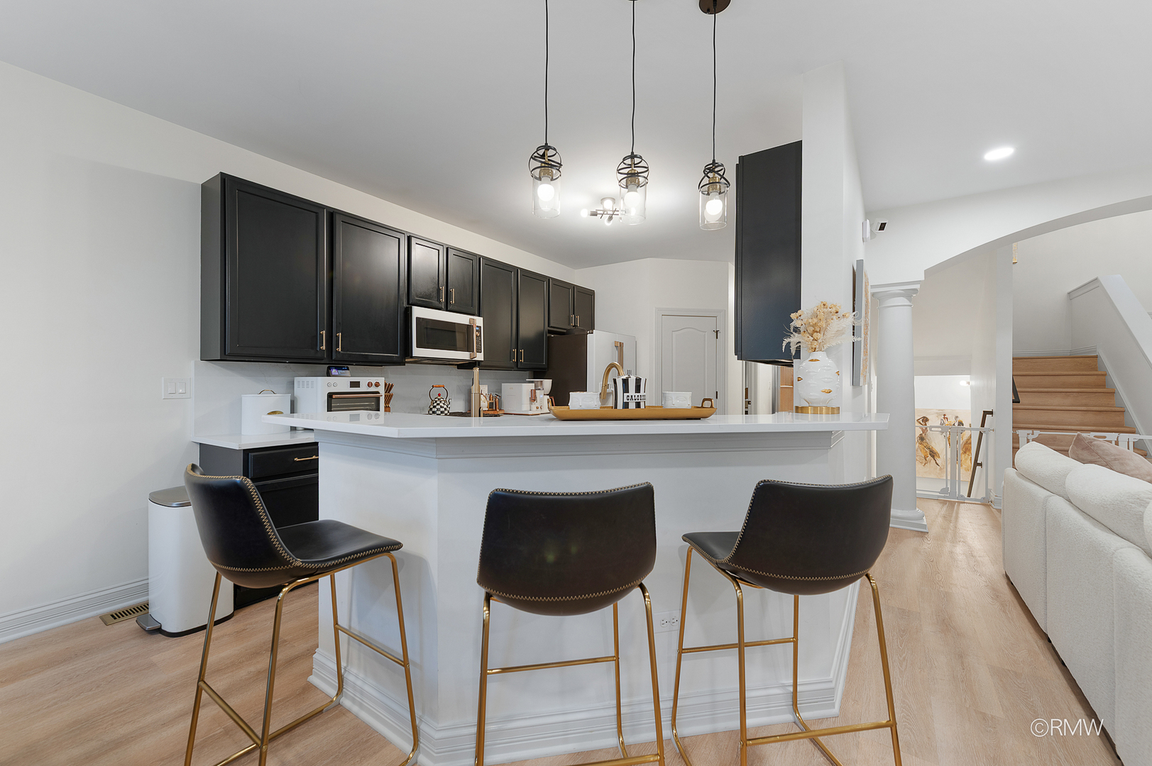 2459 Nicola Court Addison, IL 60101 - Photo 11 of 35 a kitchen with stainless steel appliances kitchen island granite countertop a stove a sink dishwasher a dining table and chairs with wooden floor