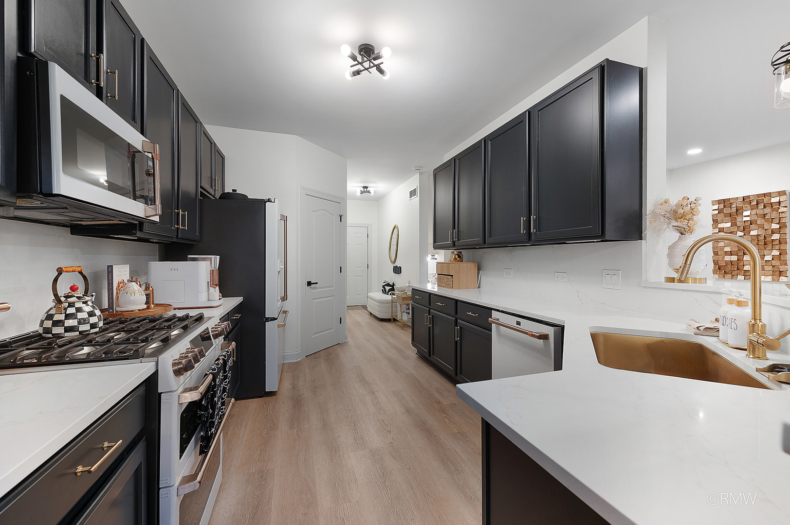 2459 Nicola Court Addison, IL 60101 - Photo 12 of 35 a kitchen with stainless steel appliances granite countertop a sink stove and refrigerator