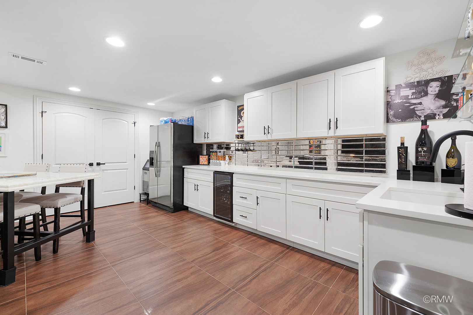 2459 Nicola Court Addison, IL 60101 - Photo 19 of 35 a kitchen with stainless steel appliances kitchen island granite countertop a stove a sink a refrigerator white cabinets and chairs with wooden floor