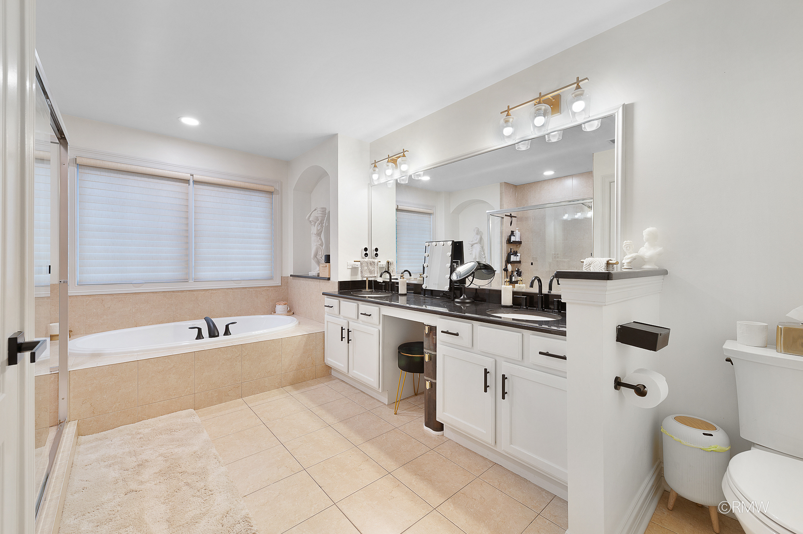 2459 Nicola Court Addison, IL 60101 - Photo 28 of 35 a large bathroom with a tub sink toilet a mirror and a bathtub