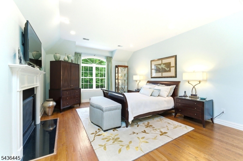4 Windemere Way Sparta, NJ 07871 - Photo 22 of 50 a bedroom with furniture fireplace and a flat screen tv