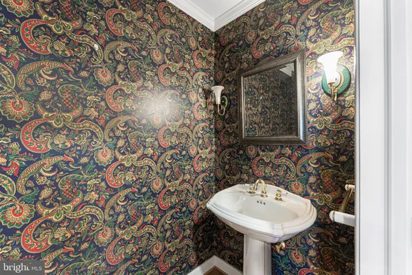 a bathroom with a sink and mirror with toilet