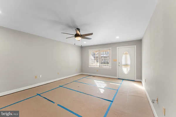 a view of a livingroom with a ceiling fan and window
