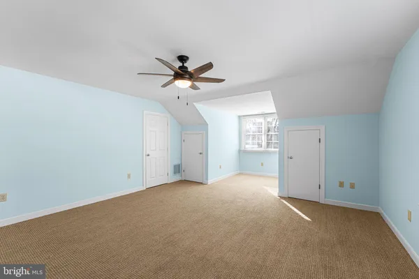 an empty room with a empty space and a ceiling fan