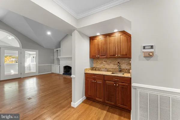 a view of kitchen and hall with wooden floor