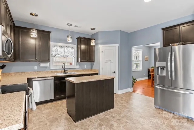 a bedroom with furniture a flat screen tv and a window