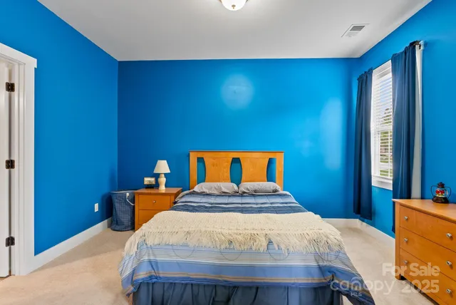 a bedroom with a bed and flat screen tv