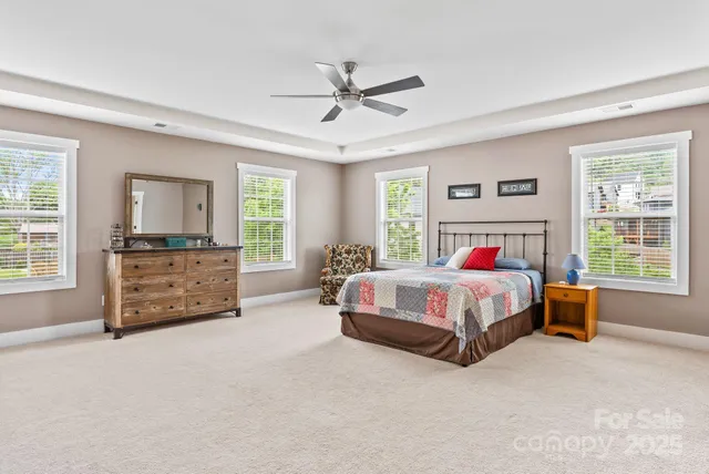 a bedroom with a large bed and a dresser