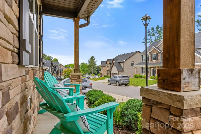 a front view of a house with garden and plants