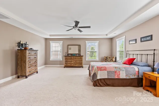 a bathroom with a granite countertop sink a toilet a mirror and shower