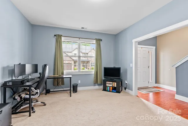 a dining room with furniture a chandelier and wooden floor