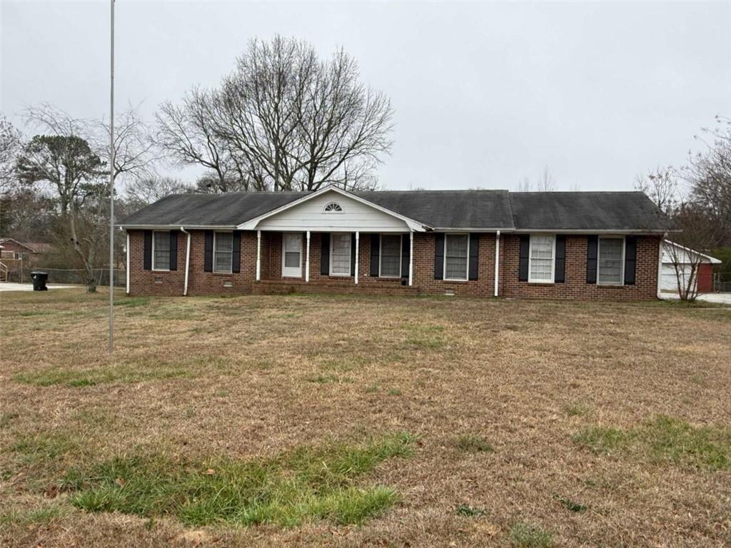 1960 Klondike Road Southwest Conyers, GA 30094 - Photo 1 of 15 a front view of a house with a garden