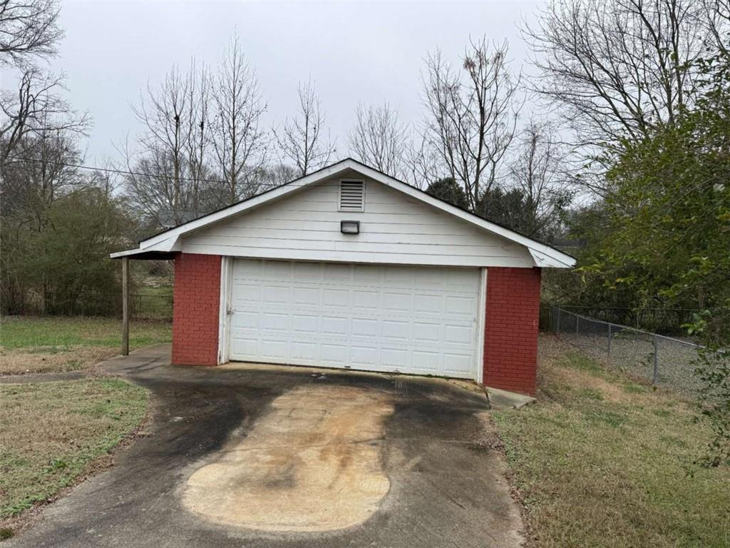 1960 Klondike Road Southwest Conyers, GA 30094 - Photo 14 of 15 a small barn with a small yard and parking space