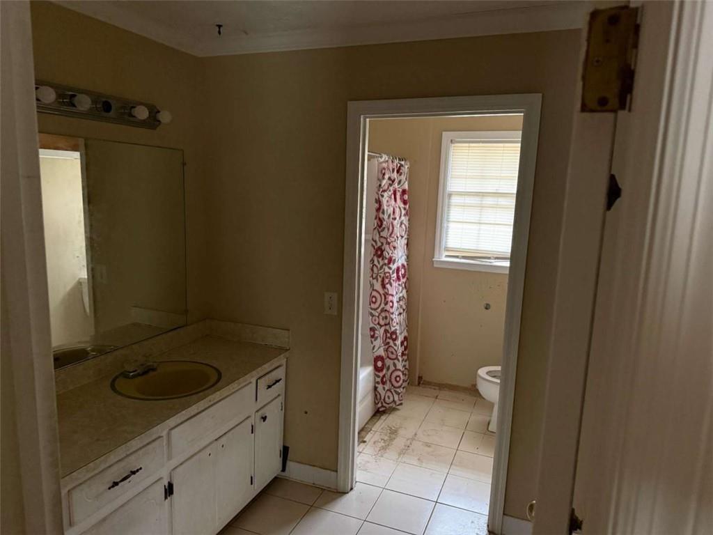 1960 Klondike Road Southwest Conyers, GA 30094 - Photo 2 of 15 a bathroom with a sink a toilet and shower