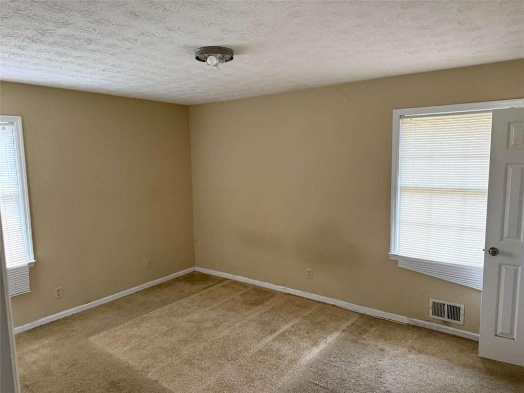 1960 Klondike Road Southwest Conyers, GA 30094 - Photo 5 of 15 an empty room with a window