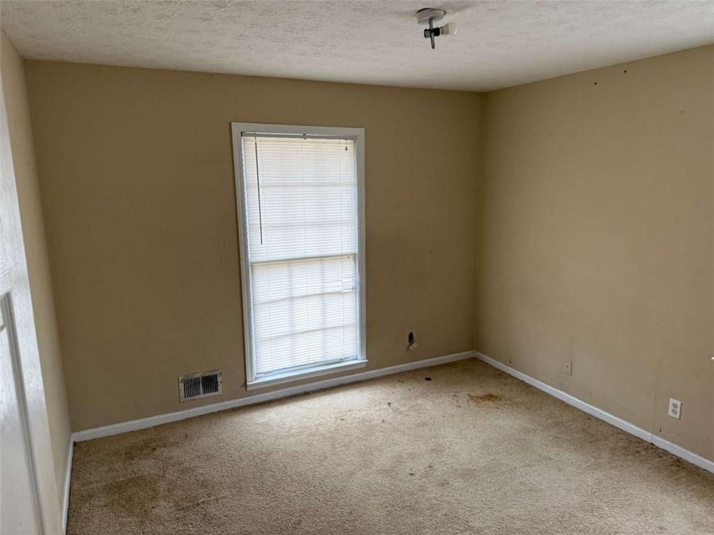 1960 Klondike Road Southwest Conyers, GA 30094 - Photo 8 of 15 an empty room with windows