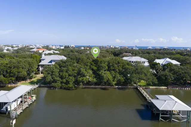 an aerial view of a house with a lake view