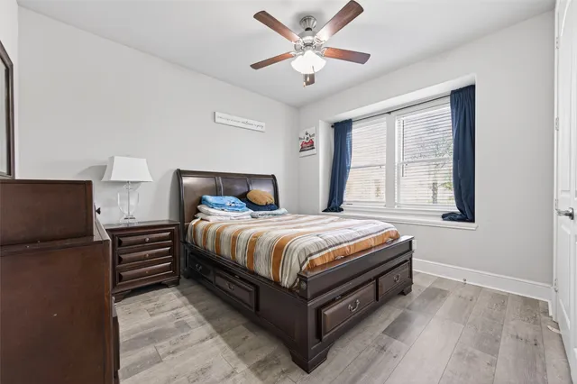 a bed sitting in a bedroom next to a window