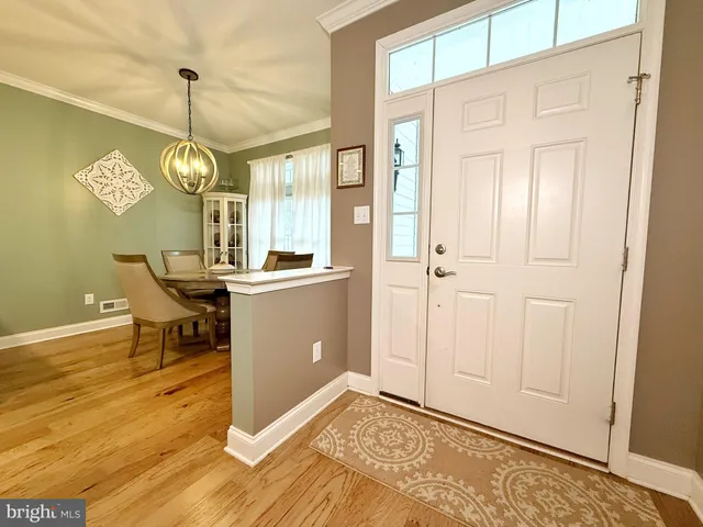 a view of a dining room with furniture and chandelier
