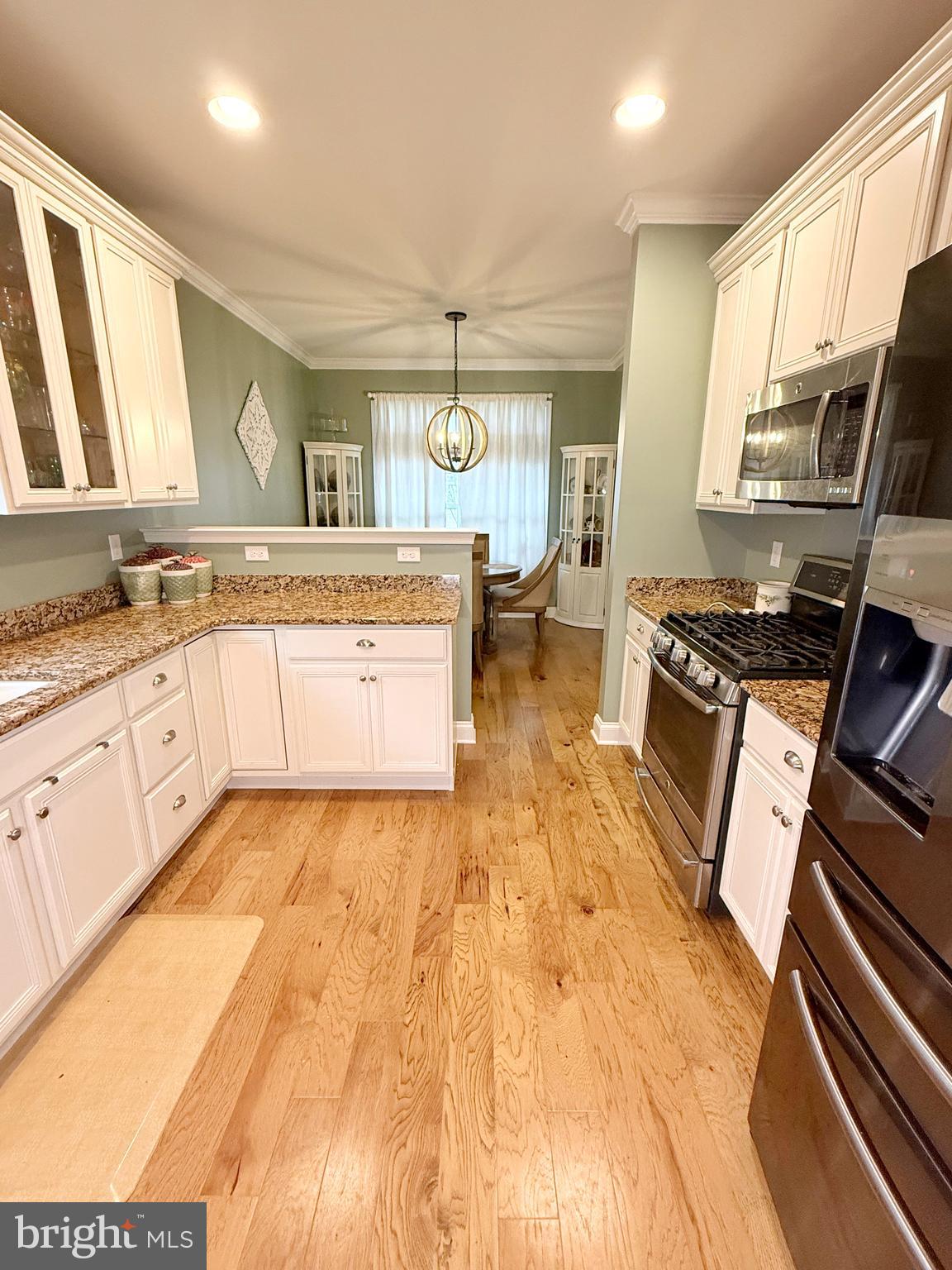 140 Weatherby Lane Glassboro, NJ 08028 - Photo 29 of 85 a large kitchen with stainless steel appliances a stove a sink dishwasher and cabinets with wooden floor