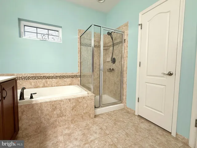 a bathroom with a bathtub and a shower