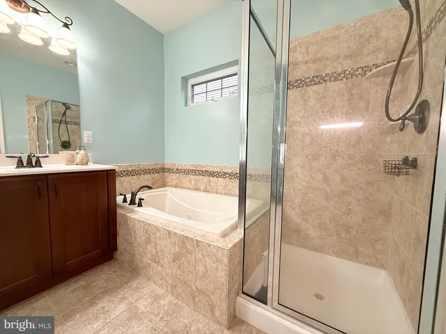 a bathroom with a tub and a shower