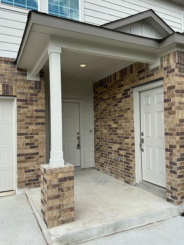 160 River Rise Road Kyle, TX 78640 - Photo 4 of 35 Covered entryway featuring a recessed light fixture, brick detailing, and a concrete landing