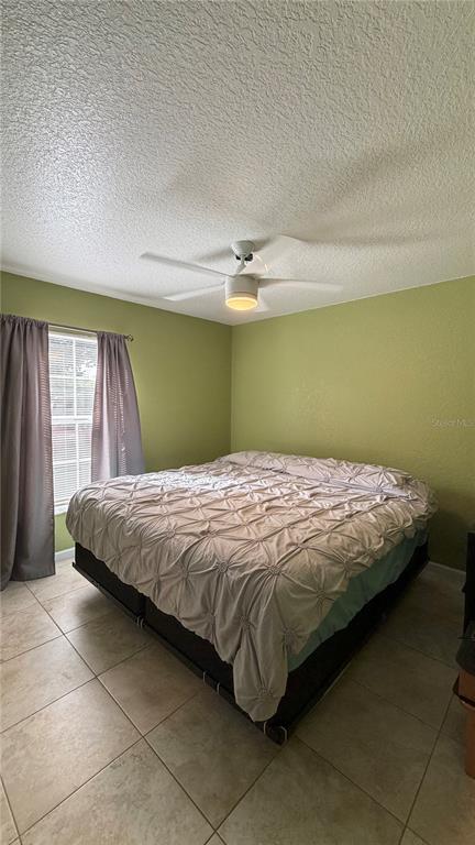655 Murphy Road Winter Springs, FL 32708 - Photo 20 of 20 a bed sitting in a bedroom next to a window and a chair