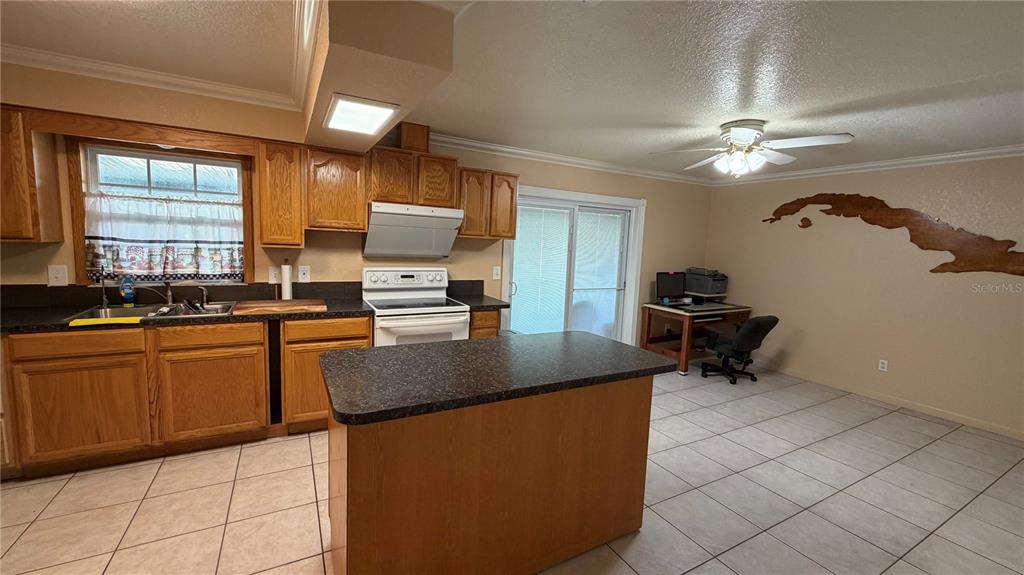 655 Murphy Road Winter Springs, FL 32708 - Photo 6 of 20 a kitchen with stainless steel appliances granite countertop a sink a stove counter space and a window