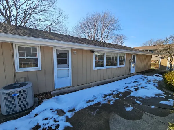 a view of a lounge chair in the back yard of the house