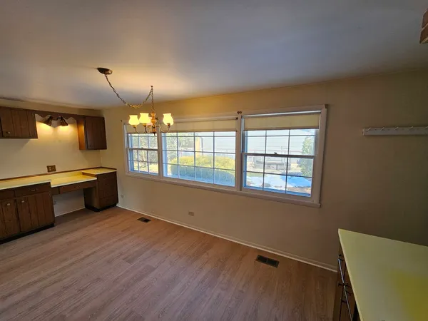 a open kitchen with window and wooden floor