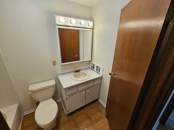 a bathroom with a toilet sink and mirror