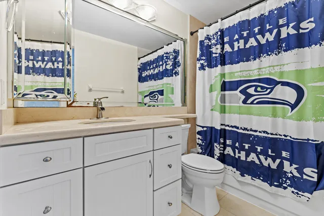 a bathroom with a sink a mirror and a toilet