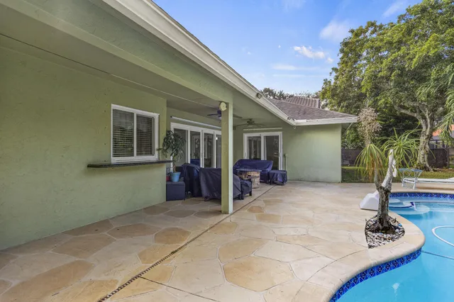 a view of a house with backyard porch and sitting area