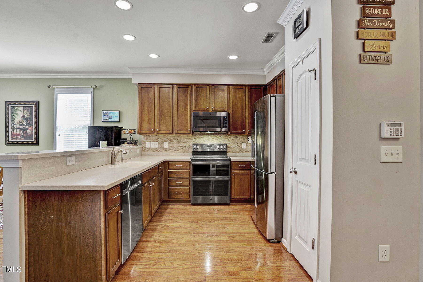 4630 Altha Street Raleigh, NC 27606 - Photo 12 of 31 a kitchen with stainless steel appliances granite countertop a refrigerator and a stove top oven